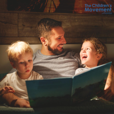 Father reading to children 
