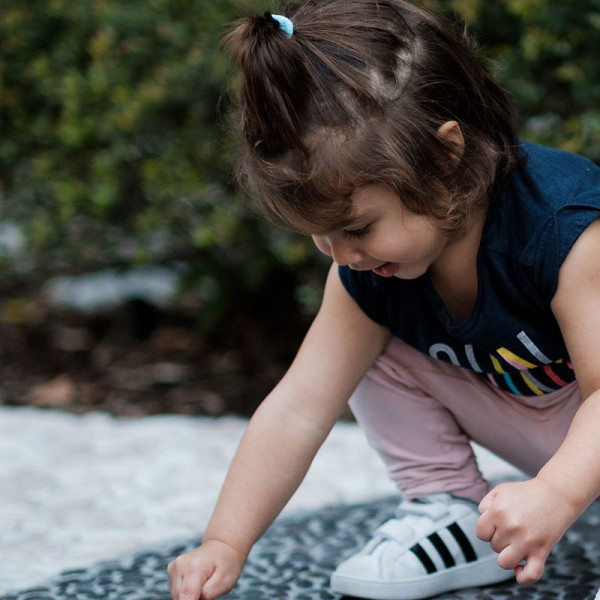 Girl pointing at ant