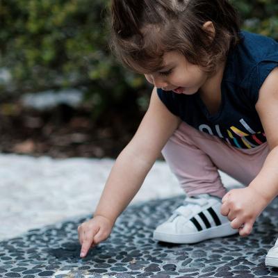 Girl pointing at ant